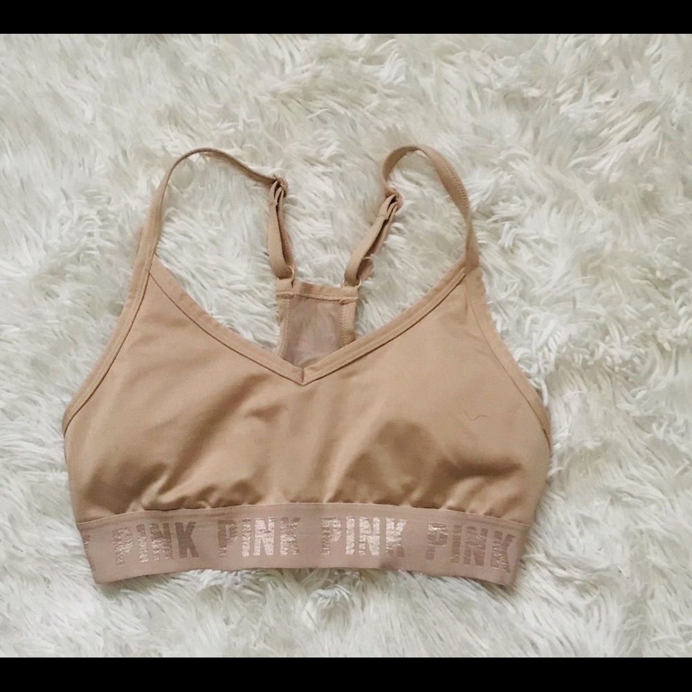 Pink Victoria’s Secret sports bra. Color nude with a sheer open/closed back.
